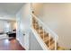 Hallway featuring wood floors and staircase leading to the upper level of the home at 1600 N Saba St # 177, Chandler, AZ 85225