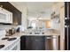 Updated kitchen with modern appliances, granite countertops, and dark wood cabinets at 1600 N Saba St # 177, Chandler, AZ 85225
