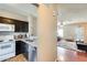 Modern kitchen with white appliances, dark cabinetry, and eat in kitchen at 1600 N Saba St # 177, Chandler, AZ 85225