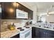 Well-appointed kitchen featuring dark wood cabinets, and granite countertops at 1600 N Saba St # 177, Chandler, AZ 85225