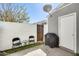 Cozy patio with chairs, a grill, and white brick wall provides a private outdoor space for relaxation at 1600 N Saba St # 177, Chandler, AZ 85225