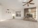 Living room featuring a tiled fireplace and large window, perfect for entertaining or relaxing at 1626 W Acoma Dr, Phoenix, AZ 85023