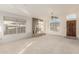 Bright living room with tile fireplace, ceiling fan, and large window at 1626 W Acoma Dr, Phoenix, AZ 85023