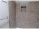 Close up on bathroom with shower stall featuring decorative tiles and an integrated niche for storage at 16528 E Gunsight Dr # 206, Fountain Hills, AZ 85268