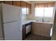 Bright kitchen equipped with white appliances, functional cabinets, and a practical layout at 16528 E Gunsight Dr # 206, Fountain Hills, AZ 85268