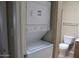 The laundry area with a stacked washer and dryer and toilet at 16528 E Gunsight Dr # 206, Fountain Hills, AZ 85268