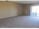 Spacious living room featuring neutral carpet and sliding glass door, offering a bright and airy atmosphere at 16528 E Gunsight Dr # 206, Fountain Hills, AZ 85268