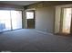 Versatile living room with neutral carpet and sliding glass doors, seamlessly connecting indoor and outdoor living spaces at 16528 E Gunsight Dr # 206, Fountain Hills, AZ 85268