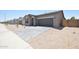 Attractive single-story home featuring a paver driveway, xeriscaped yard, and a two-car garage at 1661 N St Francis Pl, Casa Grande, AZ 85122