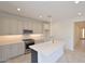 Modern kitchen with white cabinetry, stainless steel appliances, and a large island at 1661 N St Francis Pl, Casa Grande, AZ 85122