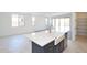Open-concept kitchen featuring a large island with a farmhouse sink and stainless steel appliances at 1661 N St Francis Pl, Casa Grande, AZ 85122