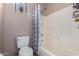 A well-maintained bathroom with a toilet, shower, and tile flooring at 17574 W Gelding Dr, Surprise, AZ 85388