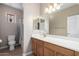 A bright bathroom with a toilet, shower, and sink at 17574 W Gelding Dr, Surprise, AZ 85388