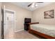 Inviting bedroom with tile floors, a television, and neutral color palette at 17574 W Gelding Dr, Surprise, AZ 85388