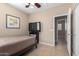 A cozy bedroom featuring tile floors, a ceiling fan, and a comfortable bed at 17574 W Gelding Dr, Surprise, AZ 85388