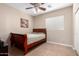Cozy bedroom featuring a ceiling fan, tile floors, and a warm, inviting atmosphere at 17574 W Gelding Dr, Surprise, AZ 85388