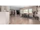 Bright dining area with tile flooring, a chandelier, and seamless access to other living spaces at 17574 W Gelding Dr, Surprise, AZ 85388