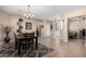 Open dining room with tile floors adjacent to the living area, perfect for gatherings at 17574 W Gelding Dr, Surprise, AZ 85388