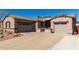 Spacious home featuring a three-car garage and desert-friendly landscaping at 17574 W Gelding Dr, Surprise, AZ 85388