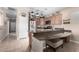 An open kitchen with stainless steel appliances, a breakfast bar, granite counters, and tile flooring at 17574 W Gelding Dr, Surprise, AZ 85388