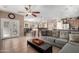 Spacious living room adjoining the kitchen, featuring tile flooring and plenty of natural light at 17574 W Gelding Dr, Surprise, AZ 85388