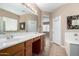 A spacious bathroom with a double sink, tile floors, and a shower at 17574 W Gelding Dr, Surprise, AZ 85388