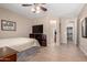 Spacious main bedroom with tile floors, neutral colors, and easy access to the bathroom and closet at 17574 W Gelding Dr, Surprise, AZ 85388