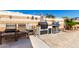 Outdoor grilling station with built-in grill and seating area, perfect for entertaining at 17574 W Gelding Dr, Surprise, AZ 85388