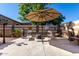 Relaxing patio area with comfortable seating, shade, and decorative accents at 17574 W Gelding Dr, Surprise, AZ 85388