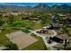 Aerial view of community park featuring a playground, volleyball court, and green space at 17594 N 98Th Way, Scottsdale, AZ 85255