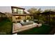 Luxurious backyard with a fire pit, seating area, and landscaped garden, perfect for outdoor entertaining at 17594 N 98Th Way, Scottsdale, AZ 85255