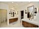 Bright bathroom with double vanity, contemporary fixtures and a view of the bedroom at 17594 N 98Th Way, Scottsdale, AZ 85255
