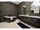 Elegant bathroom with a standalone tub, marble floors, and stylish vanity with double sinks at 17594 N 98Th Way, Scottsdale, AZ 85255