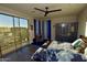 Bright bedroom offers a sliding glass door to a balcony, a ceiling fan, and spacious closet at 17594 N 98Th Way, Scottsdale, AZ 85255
