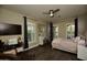 Inviting bedroom features wood floors, ceiling fan, plantation shutters, and a cozy bed at 17594 N 98Th Way, Scottsdale, AZ 85255