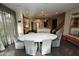 Open dining area with a large marble table and seamless flow into the kitchen at 17594 N 98Th Way, Scottsdale, AZ 85255