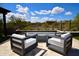 Outdoor seating area featuring a modern firepit with two chairs and a view of the surrounding desert landscape at 17594 N 98Th Way, Scottsdale, AZ 85255