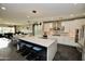 Open-concept kitchen featuring a large island with seating and modern lighting at 17594 N 98Th Way, Scottsdale, AZ 85255