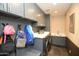 Well-organized laundry room with gray cabinets, washer, dryer, sink, and ample counter space at 17594 N 98Th Way, Scottsdale, AZ 85255