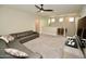 Open living area with a gray sectional, a ceiling fan, and neutral tones offers a bright and inviting space at 17594 N 98Th Way, Scottsdale, AZ 85255