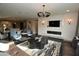 Open-concept living room features a modern fireplace, sleek furnishings and a view into the kitchen at 17594 N 98Th Way, Scottsdale, AZ 85255