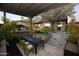 Outdoor patio featuring a dining area, comfortable seating, and a pergola offering shade and style at 17594 N 98Th Way, Scottsdale, AZ 85255