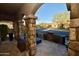 Covered porch with stone pillars and outdoor seating with street views at 17594 N 98Th Way, Scottsdale, AZ 85255