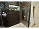 Contemporary shower with geometric tile work, rainfall shower head, and built-in shelving at 17594 N 98Th Way, Scottsdale, AZ 85255