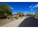 Scenic street view of a home with desert landscaping and mature trees at 17594 N 98Th Way, Scottsdale, AZ 85255
