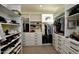 Spacious walk-in closet with custom shelving and plenty of storage space at 17594 N 98Th Way, Scottsdale, AZ 85255