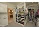 Well-organized walk-in closet with custom storage solutions and ample shelving at 17594 N 98Th Way, Scottsdale, AZ 85255