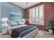 Stylish bedroom with a large window, textured wall, and a comfortable bed with blue accents at 18155 N Sterling Dr, Surprise, AZ 85374
