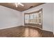 Bright bedroom features a bay window with shutters and hardwood floors at 18155 N Sterling Dr, Surprise, AZ 85374