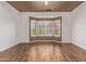 Bright bedroom features a bay window with shutters and hardwood floors at 18155 N Sterling Dr, Surprise, AZ 85374